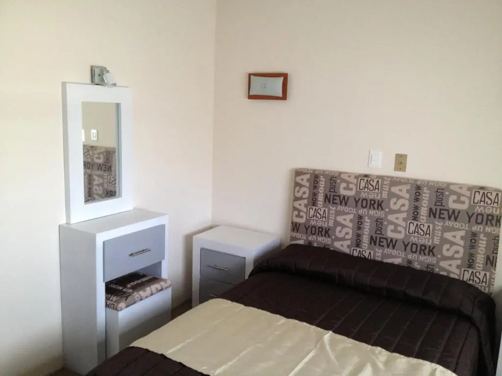 Bed and dressing area in a Hotel Central guest room